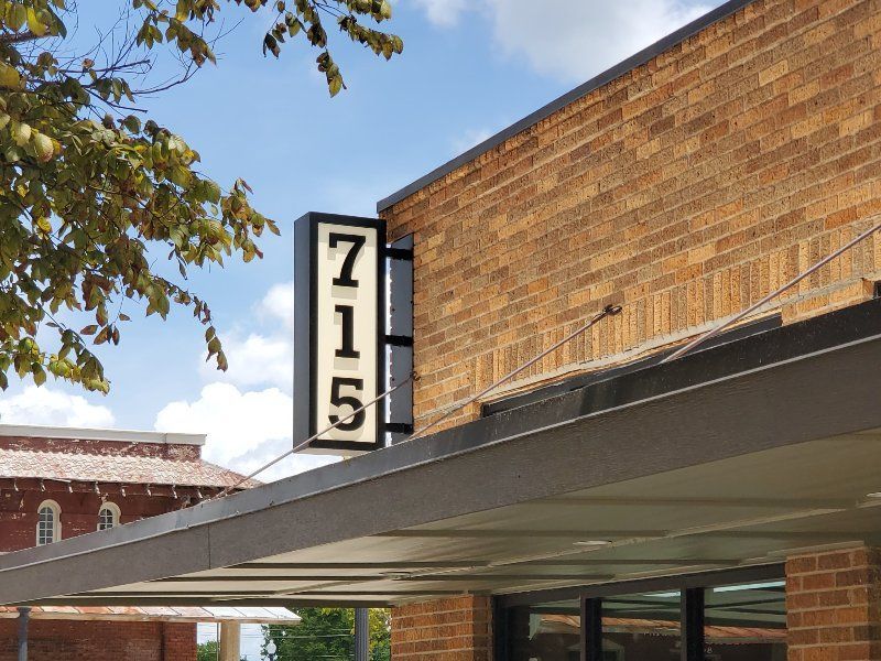 A brick building with a sign that says 715 on it