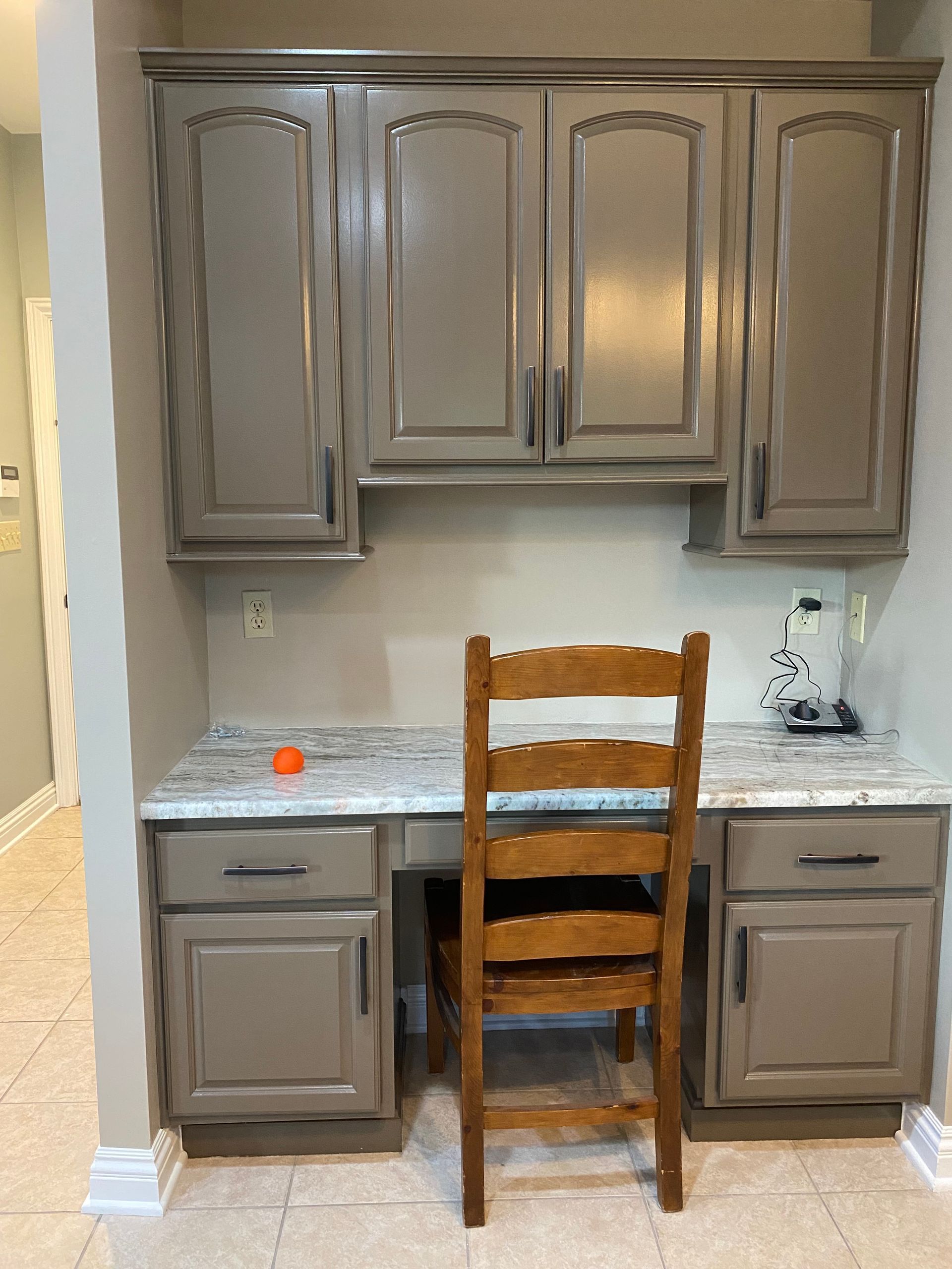 a wood cabinets and a chair (After)