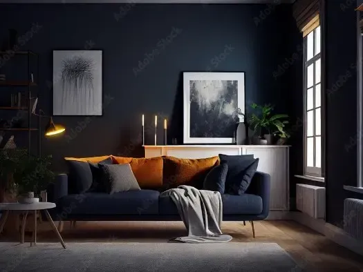 Navy blue living room with a couch, art, and plants.