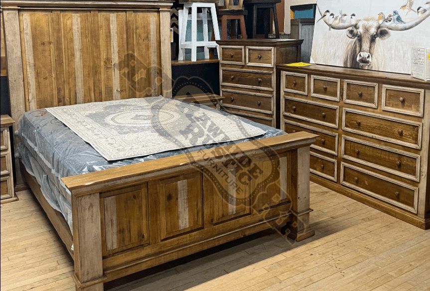Bedroom furniture set: wooden bed, chest of drawers, and dresser with a decorative bull painting on the wall.