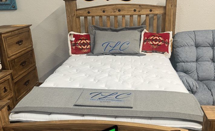 Wooden bed frame with mattress and pillows. Gray and red accents.