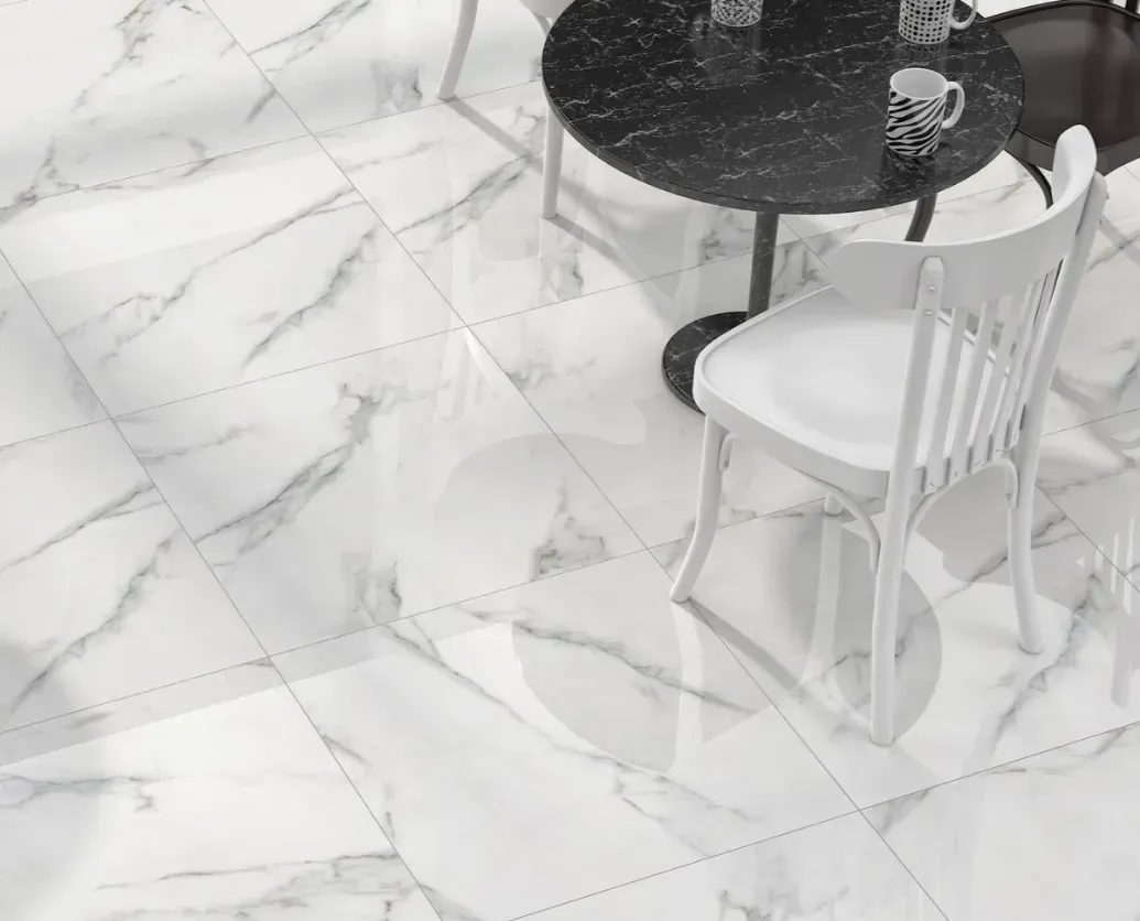 A white marble floor with grey veins, featuring a small round black table and a white chair.