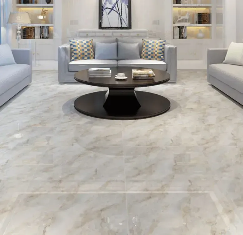A living room with gray sofas, a round coffee table, and light marble-patterned tile flooring.