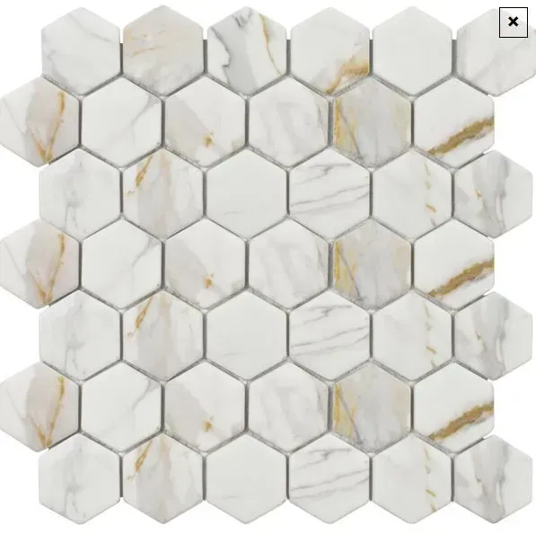 White hexagon marble tiles with grey and gold veining arranged in a honeycomb pattern on a mesh backing.