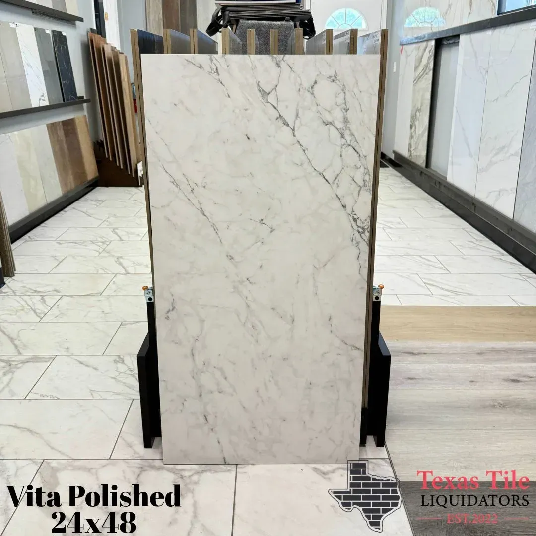 A 24x48 Vita Polished tile with a white marble pattern on display in a showroom at Texas Tile Liquidators.