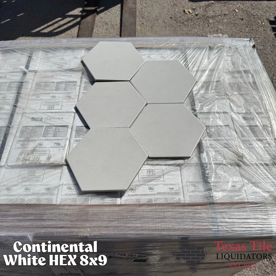 A pallet of white hexagonal tiles wrapped in plastic, labeled 