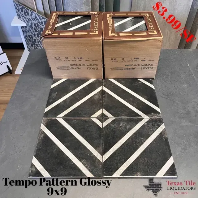 Four black and white patterned 9x9 tiles displayed in front of two boxes at Texas Tile Liquidators. Price is $3.99.