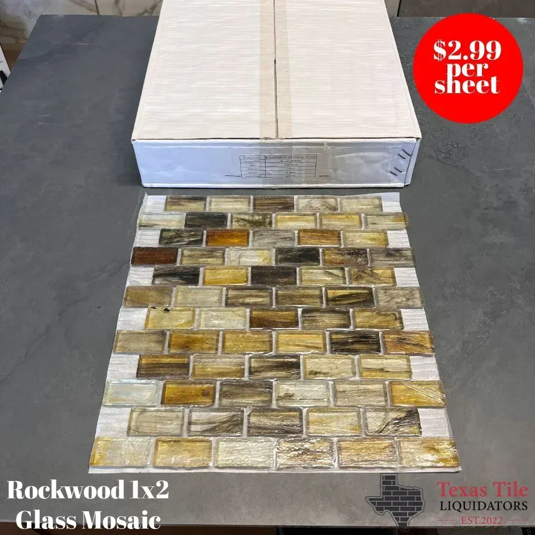 A sheet of brown, tan, and cream-colored glass brick tiles with a box, labeled $2.99 per sheet at Texas Tile Liquidators.