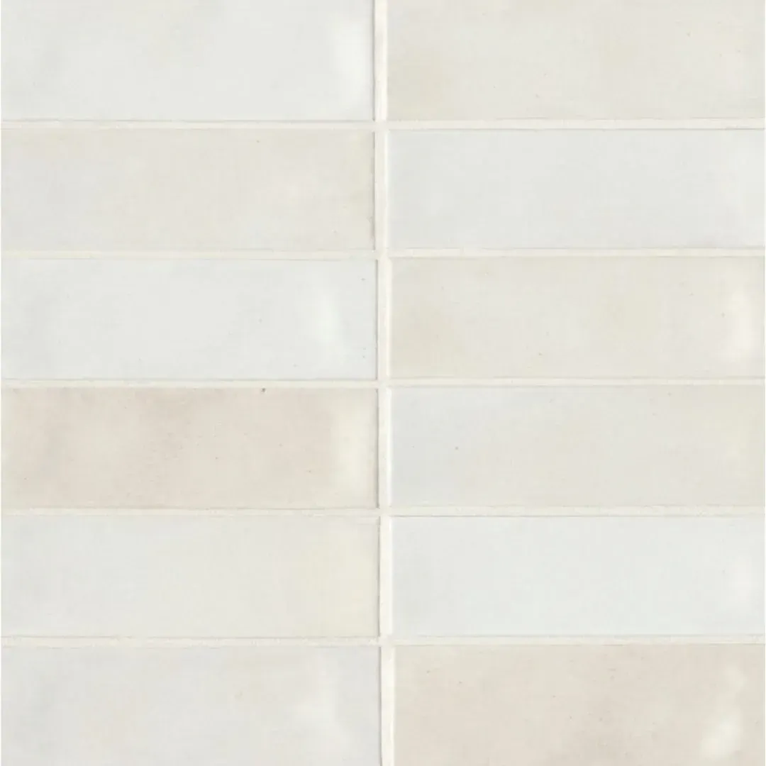 A vertical grid of rectangular, glossy white and off-white ceramic wall tiles arranged in a stacked bond pattern.