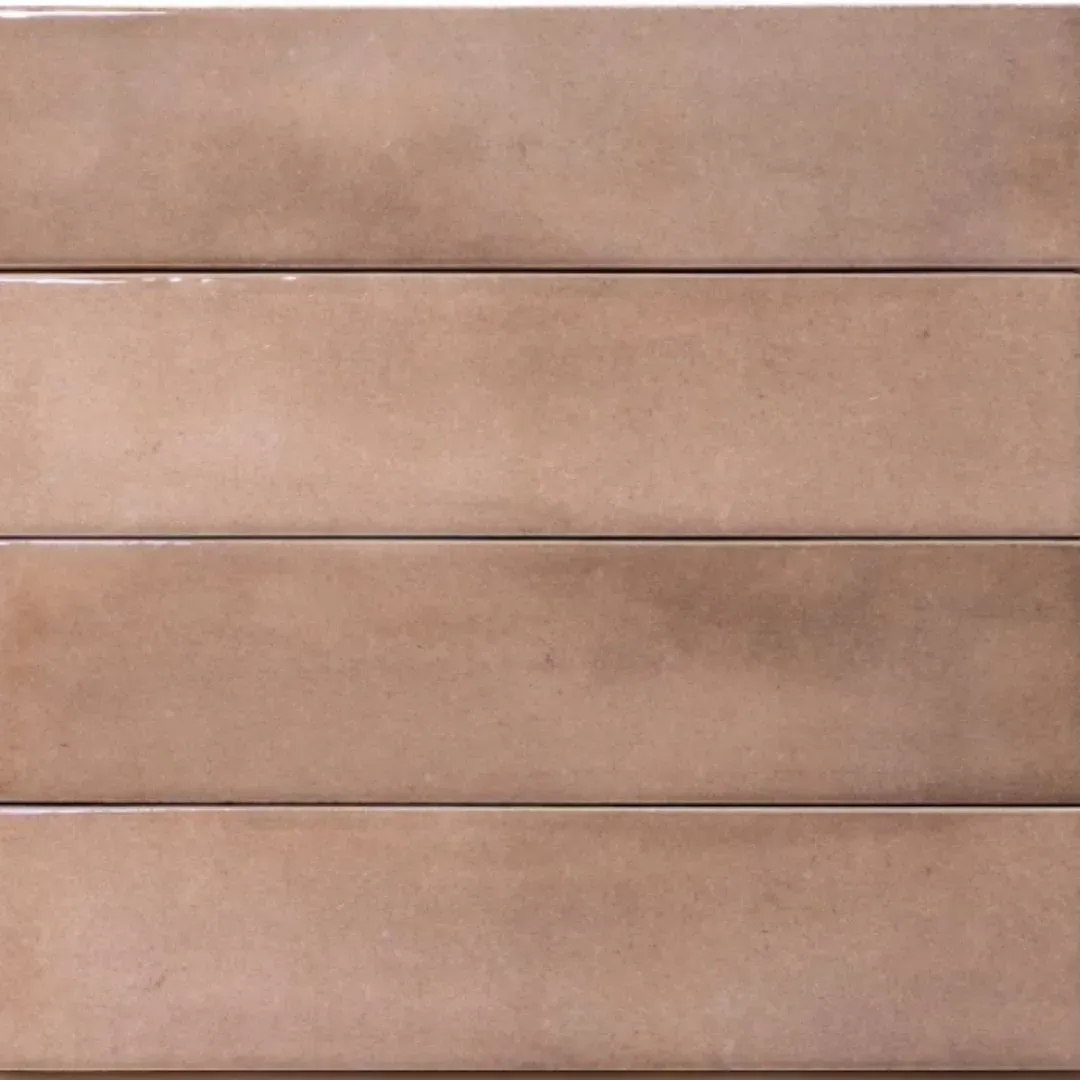 A close-up of four rectangular, glossy tan tiles stacked horizontally with thin grout lines between them.