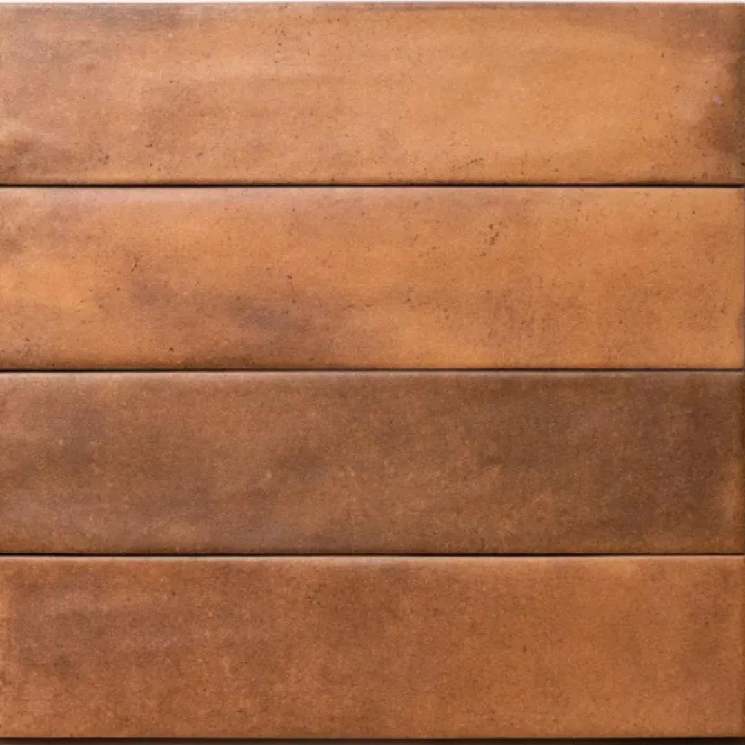 A close-up of four horizontal, rectangular terracotta-colored ceramic tiles with mottled brown and orange tones.