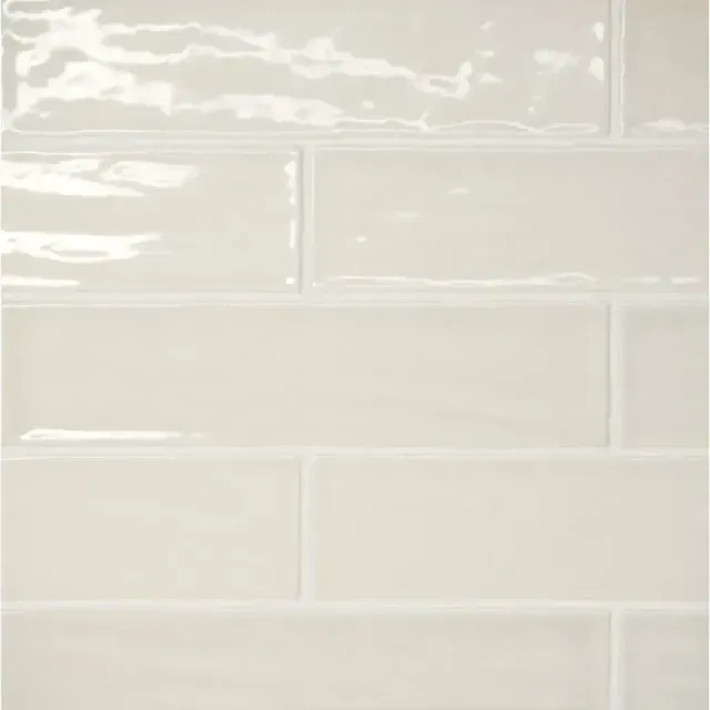 A wall of glossy, rectangular, off-white subway tiles arranged in a staggered running bond pattern.