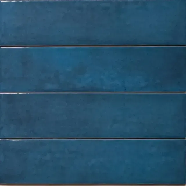 A stack of four rectangular, glossy, deep blue ceramic tiles with subtle color variations.