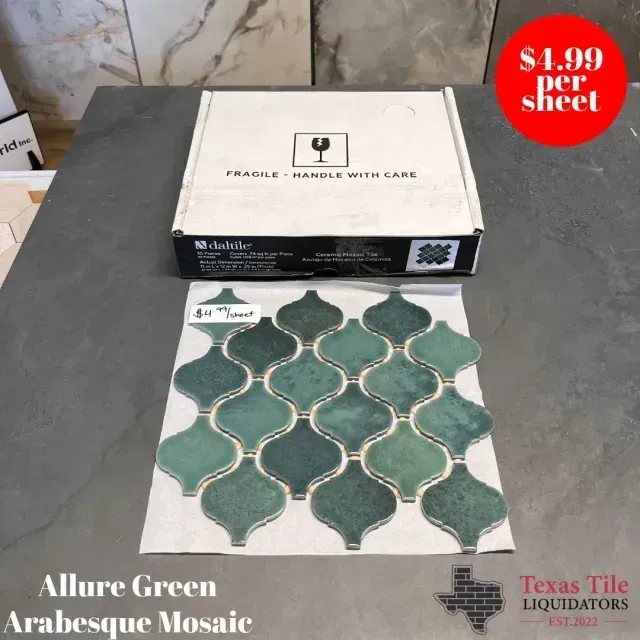 A sheet of green arabesque mosaic tile rests on a dark surface in front of its cardboard box, priced at $4.99 per sheet.