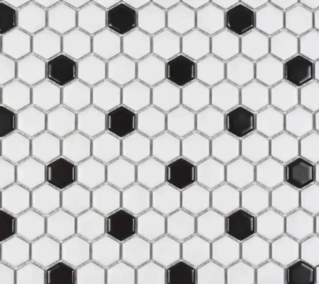A repeating hexagonal tile pattern in white with black accent tiles placed at regular intervals.