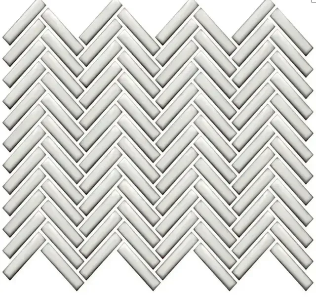 A seamless pattern of rectangular white tiles arranged in a classic herringbone layout.