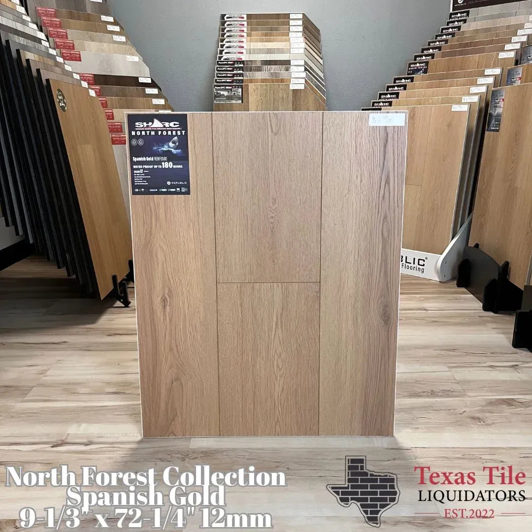 A light oak laminate flooring sample from the North Forest Collection labeled Spanish Gold at Texas Tile Liquidators.