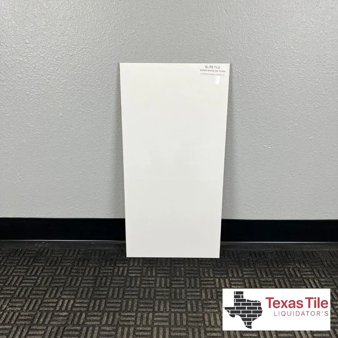 A large, glossy white rectangular tile stands upright against a gray wall, with a Texas Tile and Countertops logo below.