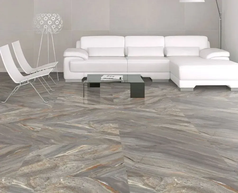 A modern, minimalist living room featuring a white sectional sofa, two white chairs, a small coffee table, and stone floors.