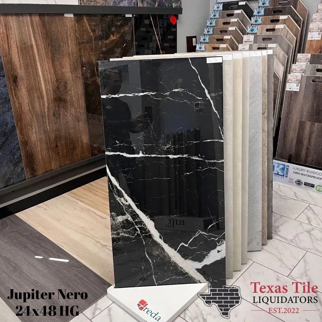 A display rack at Texas Tile Liquidators featuring black marble-look Jupiter Nero 24x48 tiles with white veining.