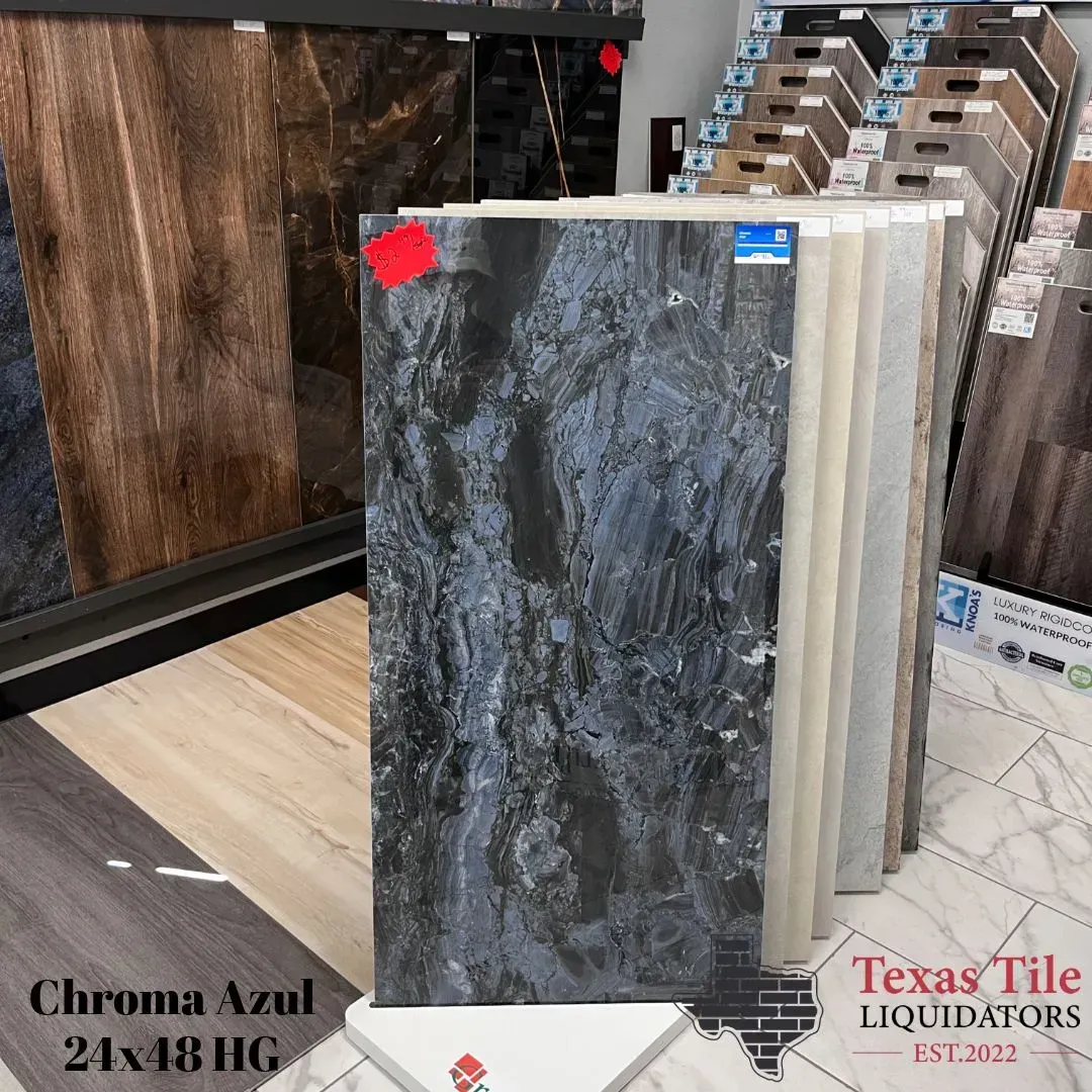 A showroom display featuring a large, dark blue marble-patterned tile, labeled 