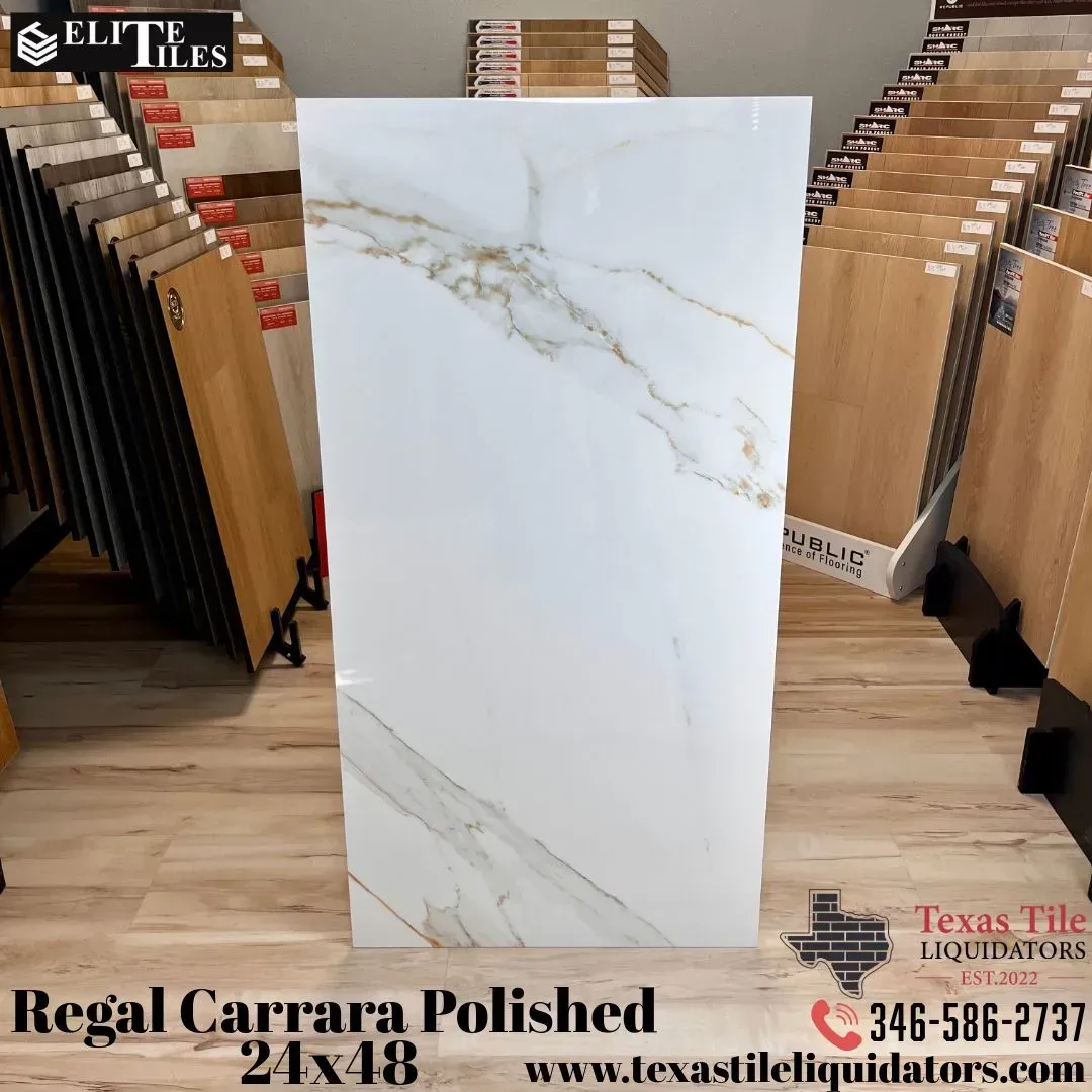 A Regal Carrara polished tile (24x48) featuring a white surface with gold veining, displayed in a tile showroom.