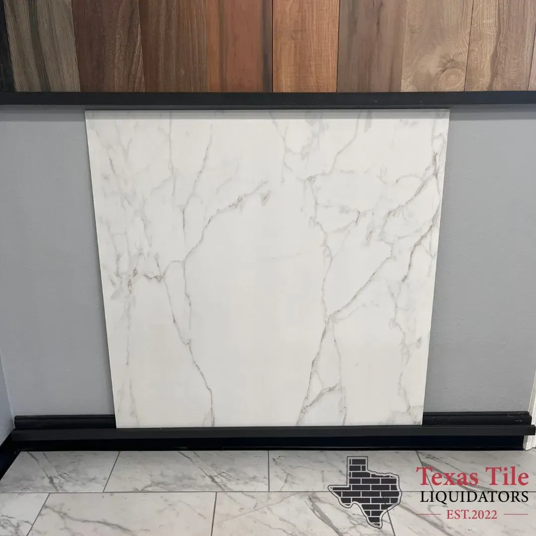 A white marble-style floor tile displayed upright against a gray wall, with wood samples above and a logo in the corner.