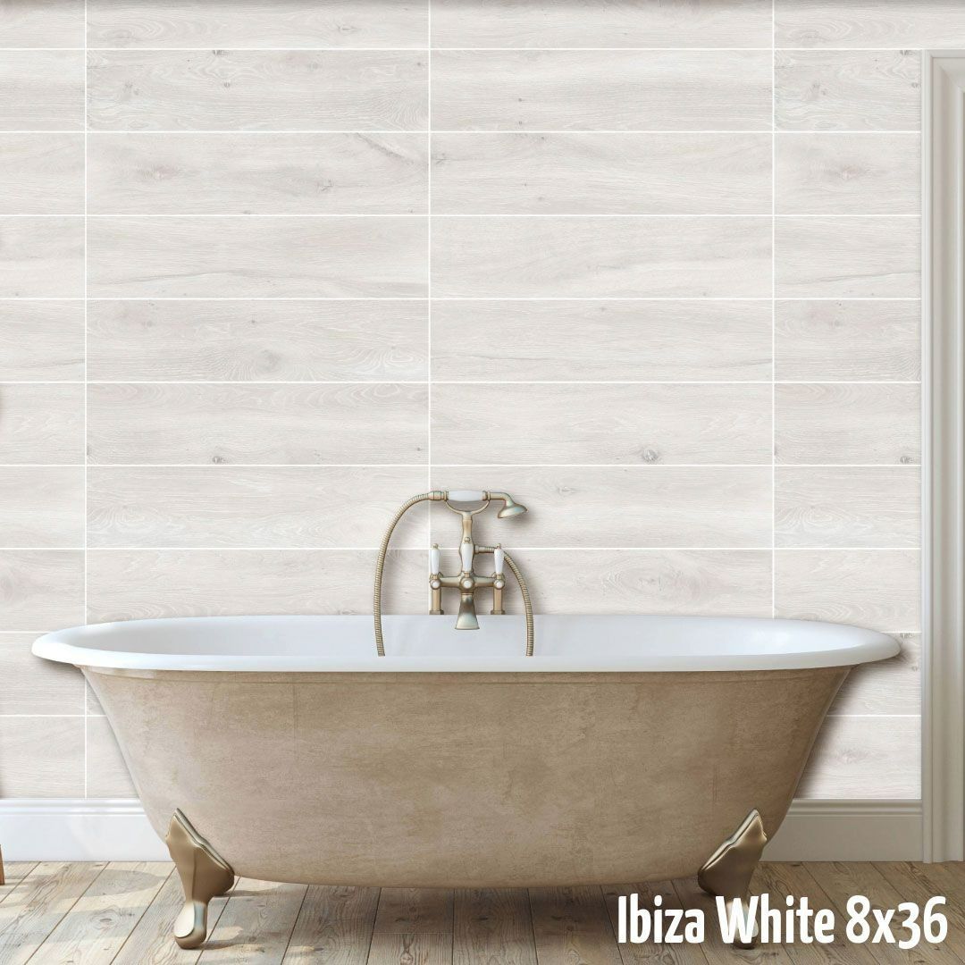 A white claw-foot bathtub centered against a wall of light, wood-look horizontal tiles labeled 