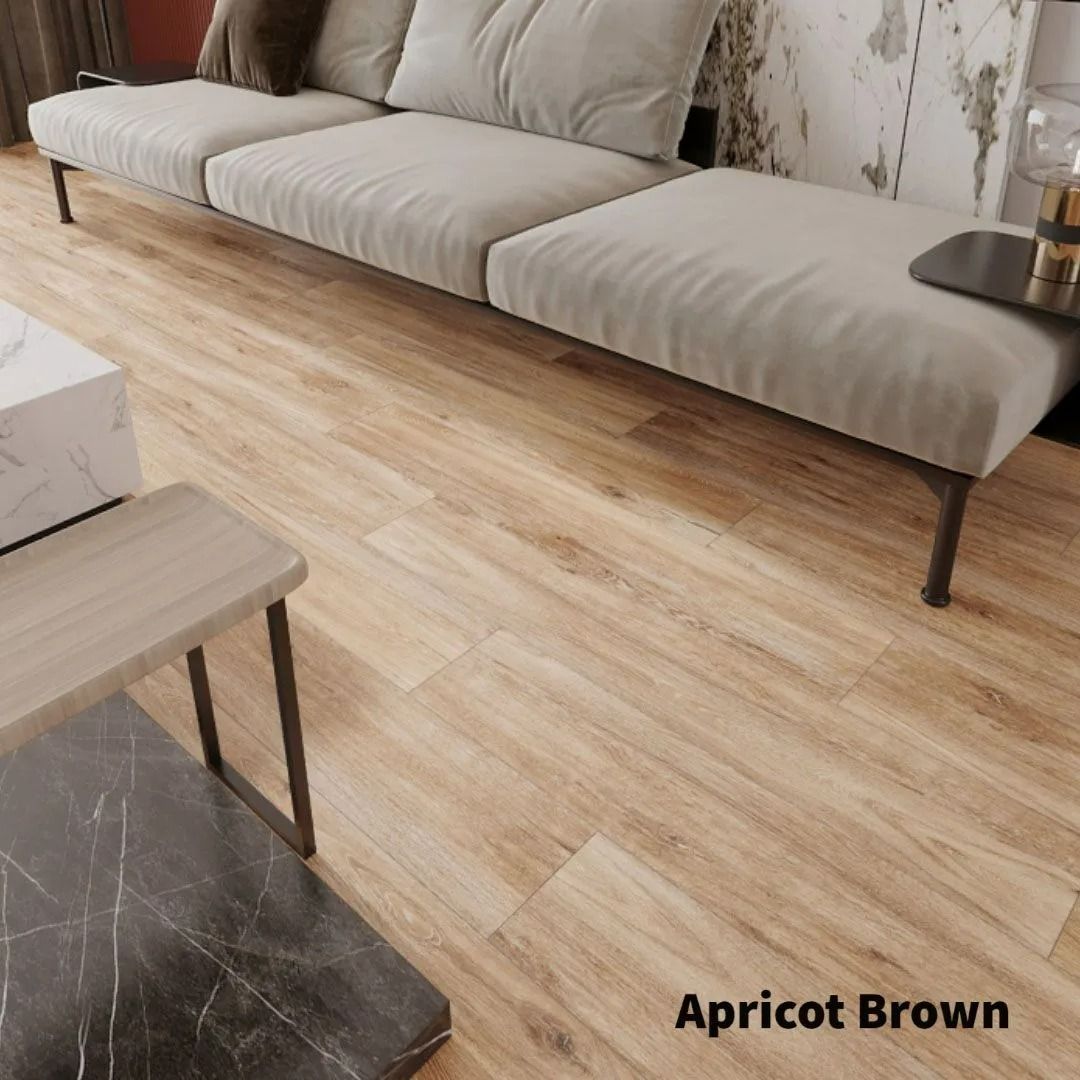 A light-toned wood-look floor with natural grain patterns, labeled as Apricot Brown, in a modern living room setting.