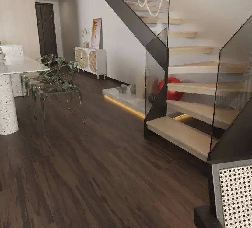 Modern interior room with dark wood flooring, a staircase with glass railings, a dining table, and a white cabinet.