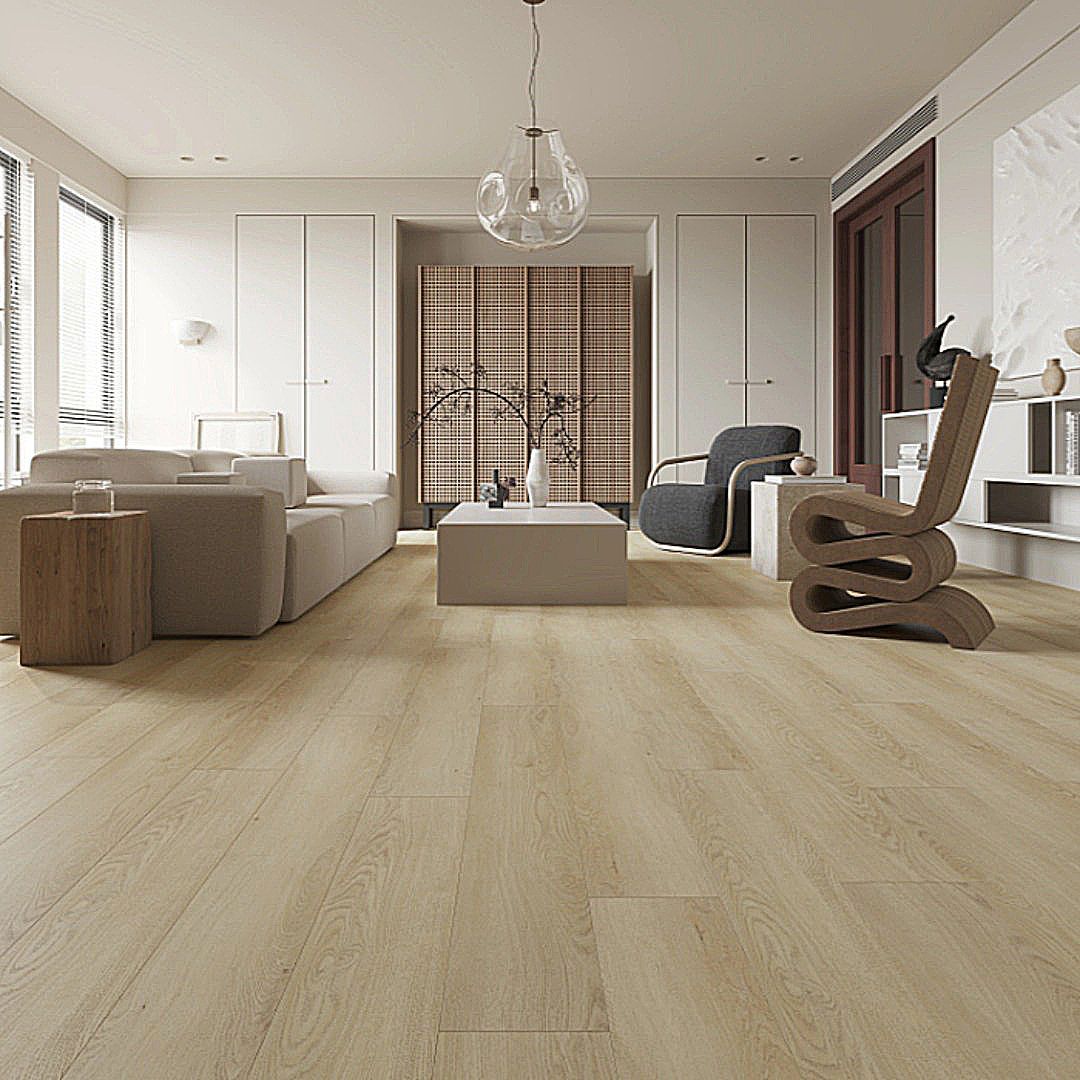 A bright, modern living room with light wood flooring, a beige sofa, a central coffee table, and an abstract wood chair.