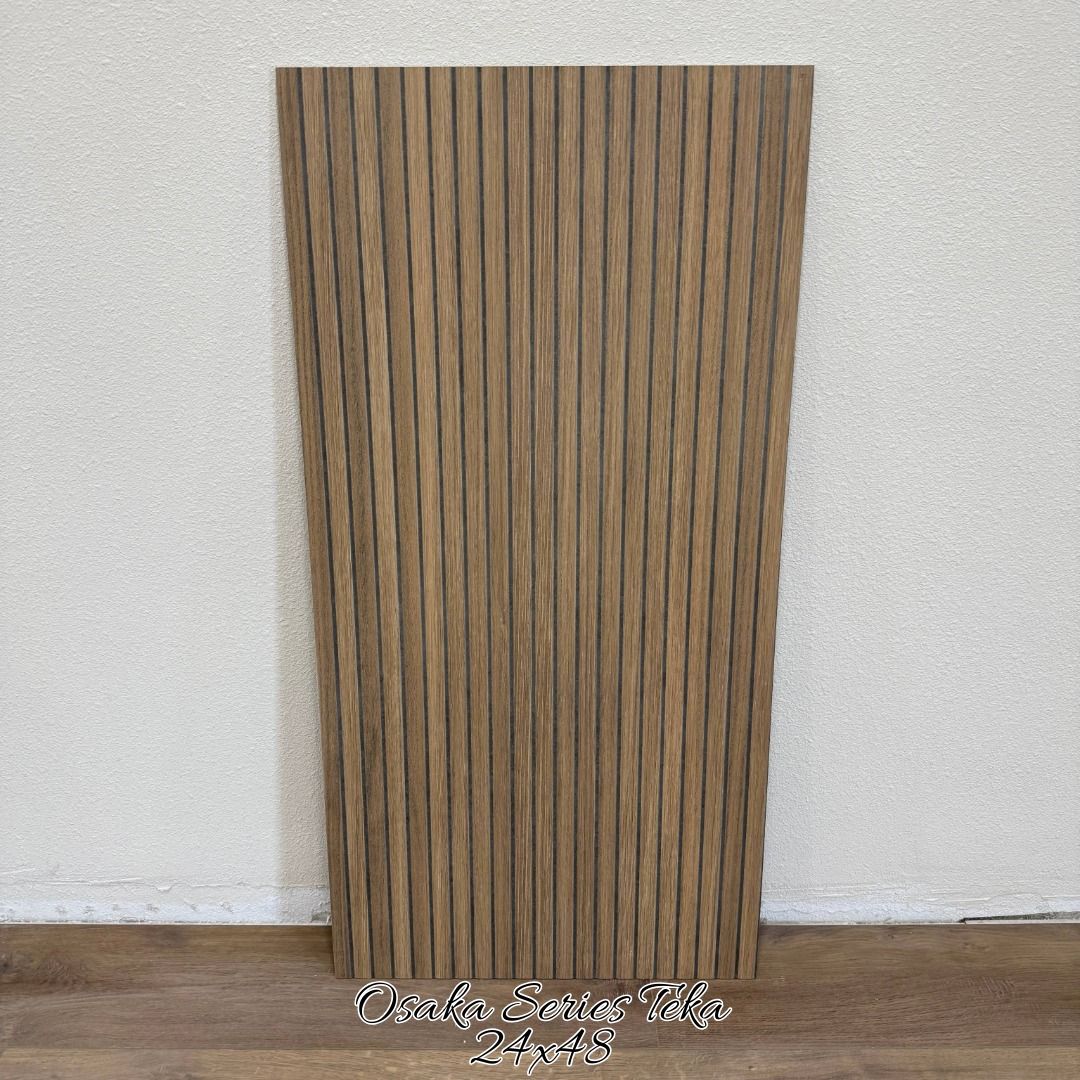 A vertical rectangular panel featuring a light-to-medium brown wood grain finish with consistent, dark vertical grooves.