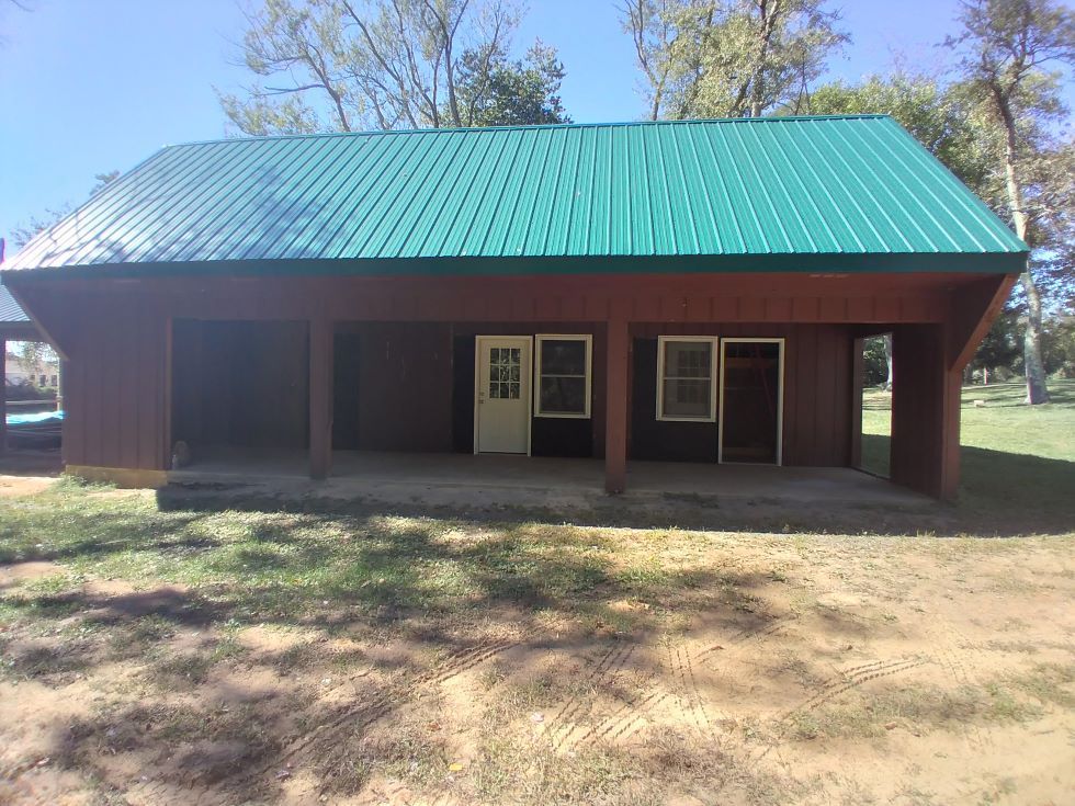A house with a green roof and a porch