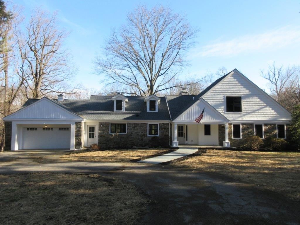 A large white house with a black roof