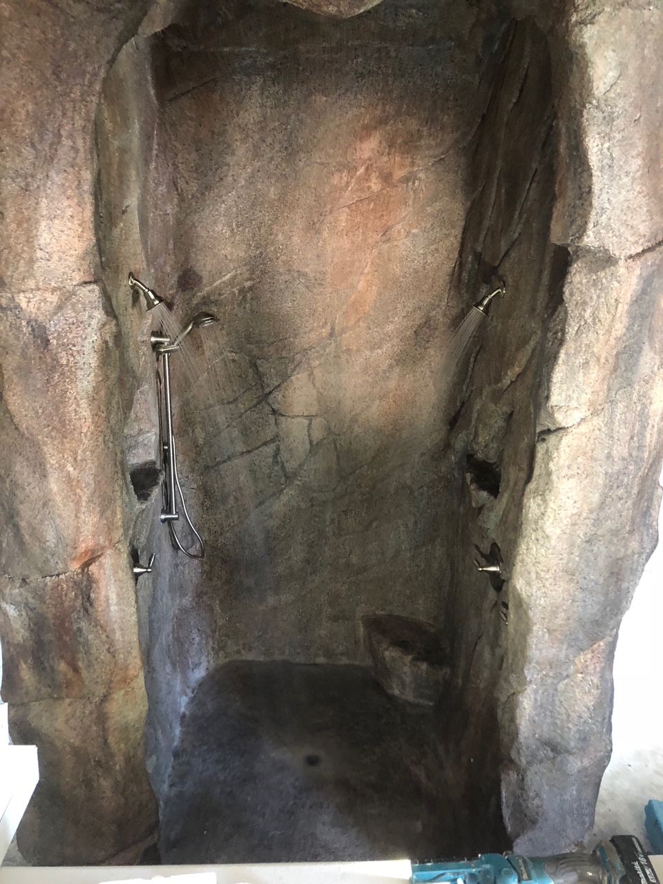 It looks like a cave with a shower in it.