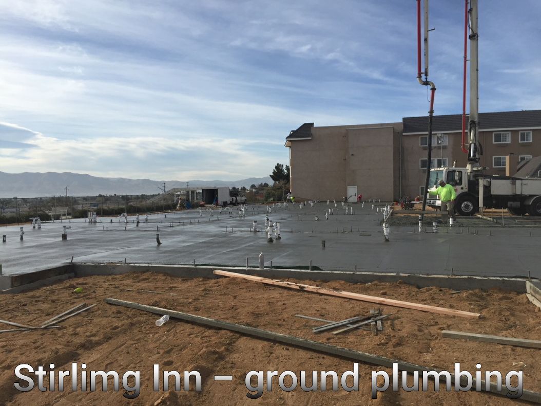 A picture of a building under construction with the words stirling inn - ground plumbing
