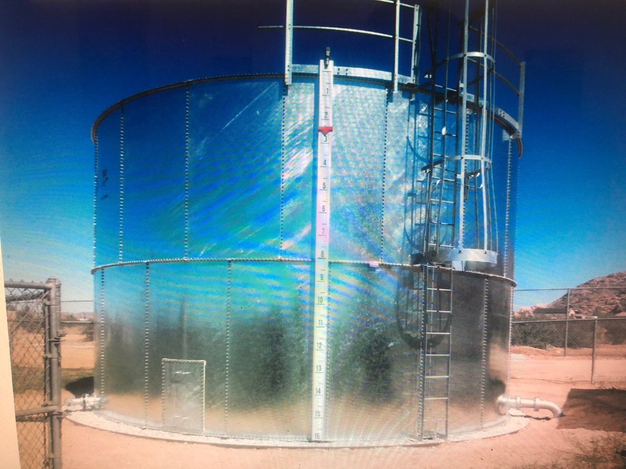 A large metal tank with a ladder attached to it