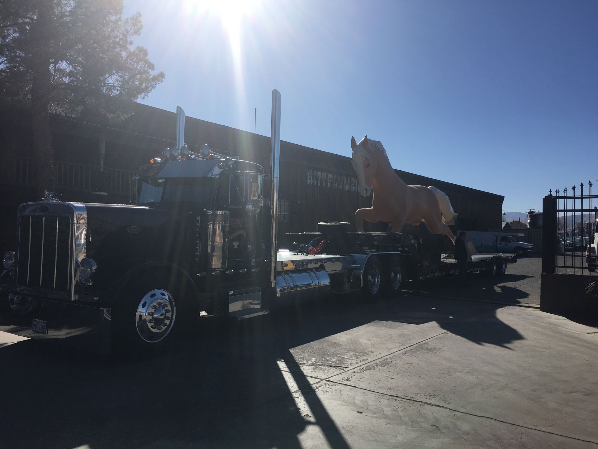 A dump truck is parked in front of a building.
