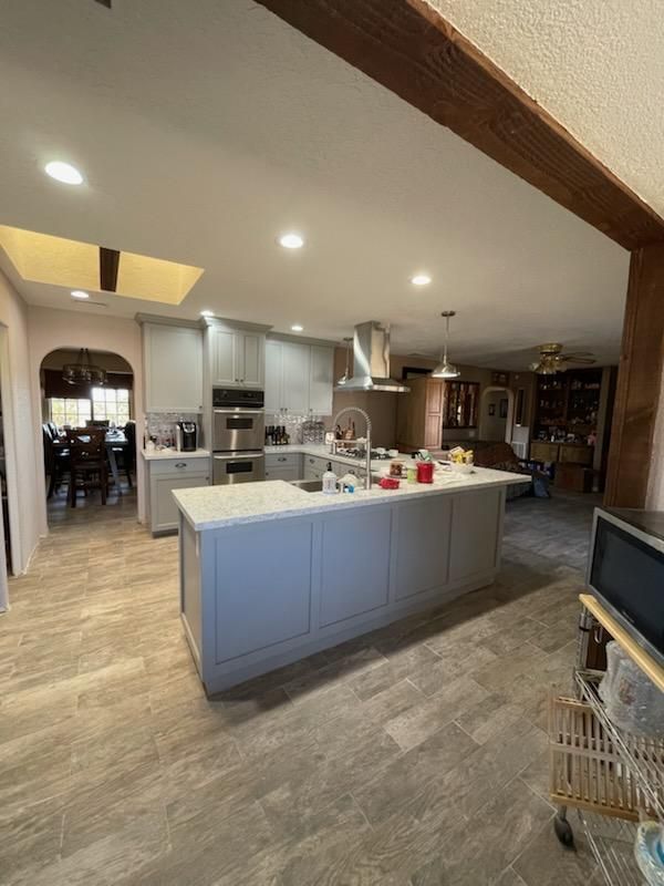 A kitchen with a large island in the middle of it.