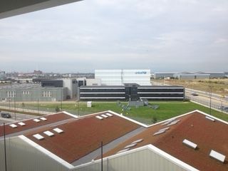 View of a modern building complex under a cloudy sky, with UNICEF logo visible on a white building.