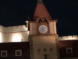 Clock tower at night, lit from below, showing the time is near midnight.