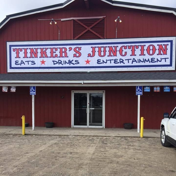 A red building with a sign that says tinker 's junction