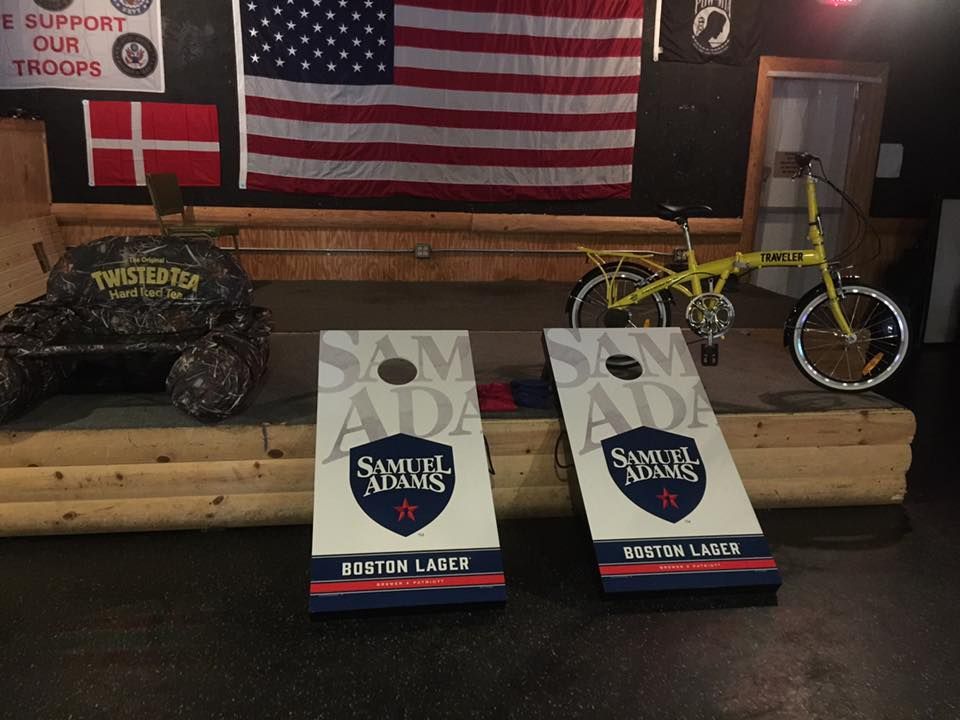 Two sam adams bags are sitting on a stage in front of an american flag