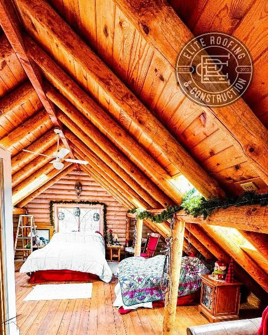 Rustic log cabin bedroom with sloped wooden ceiling. Bed, furniture, and natural light.