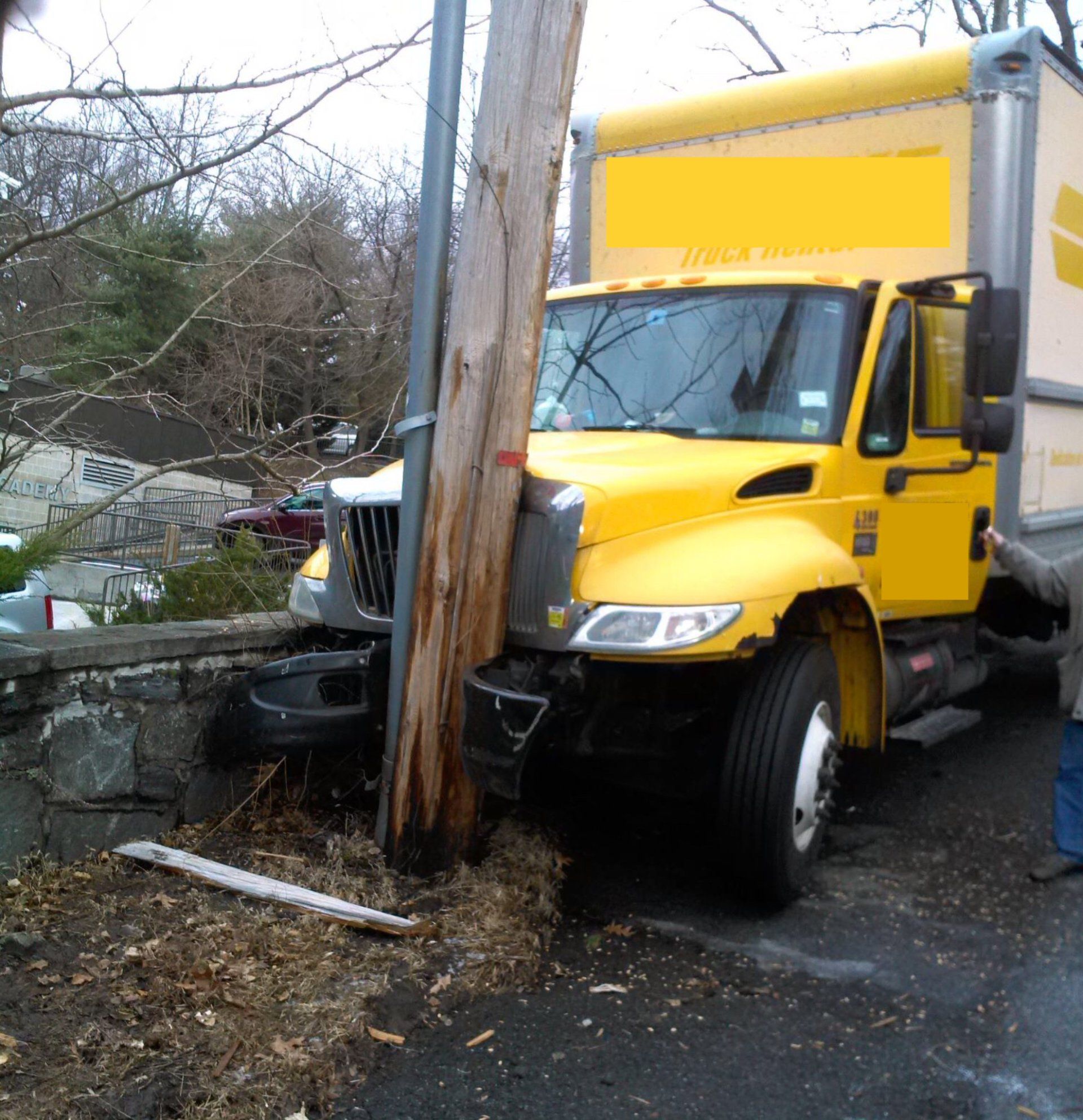 yellow truck crashed on a post