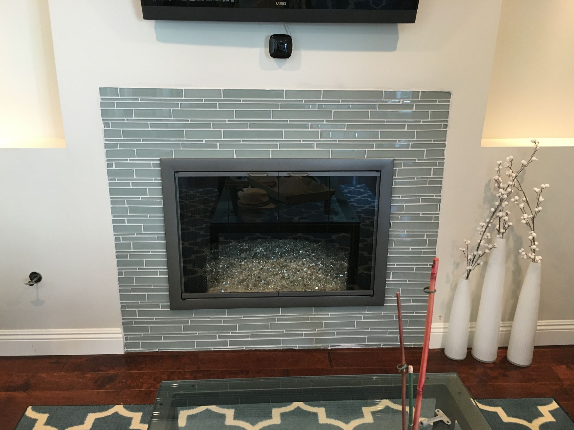 A living room with a fireplace and a flat screen TV.
