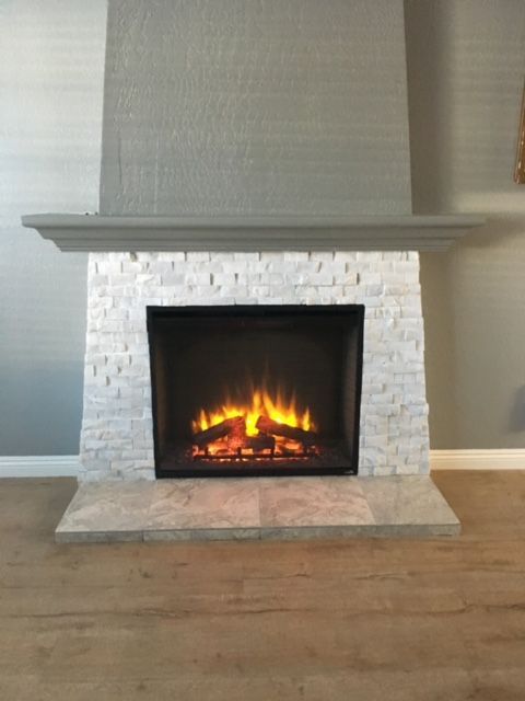 A fireplace in a living room with a wooden floor.