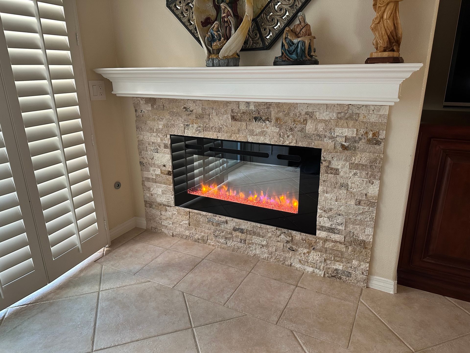 There is a fireplace in the corner of the room.