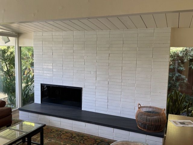 There is a fireplace in the middle of the living room.