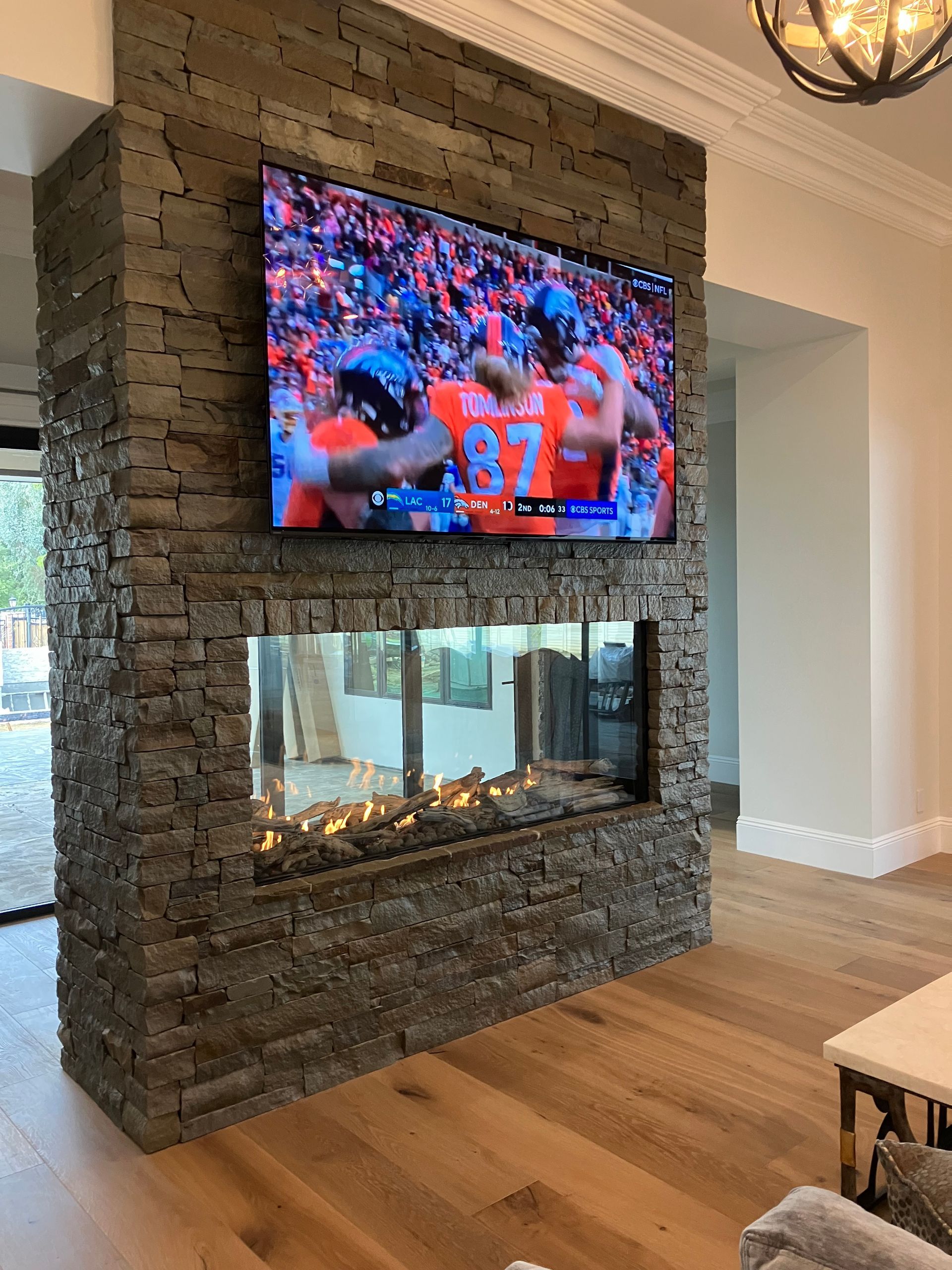 A living room with a fireplace and a flat screen TV.